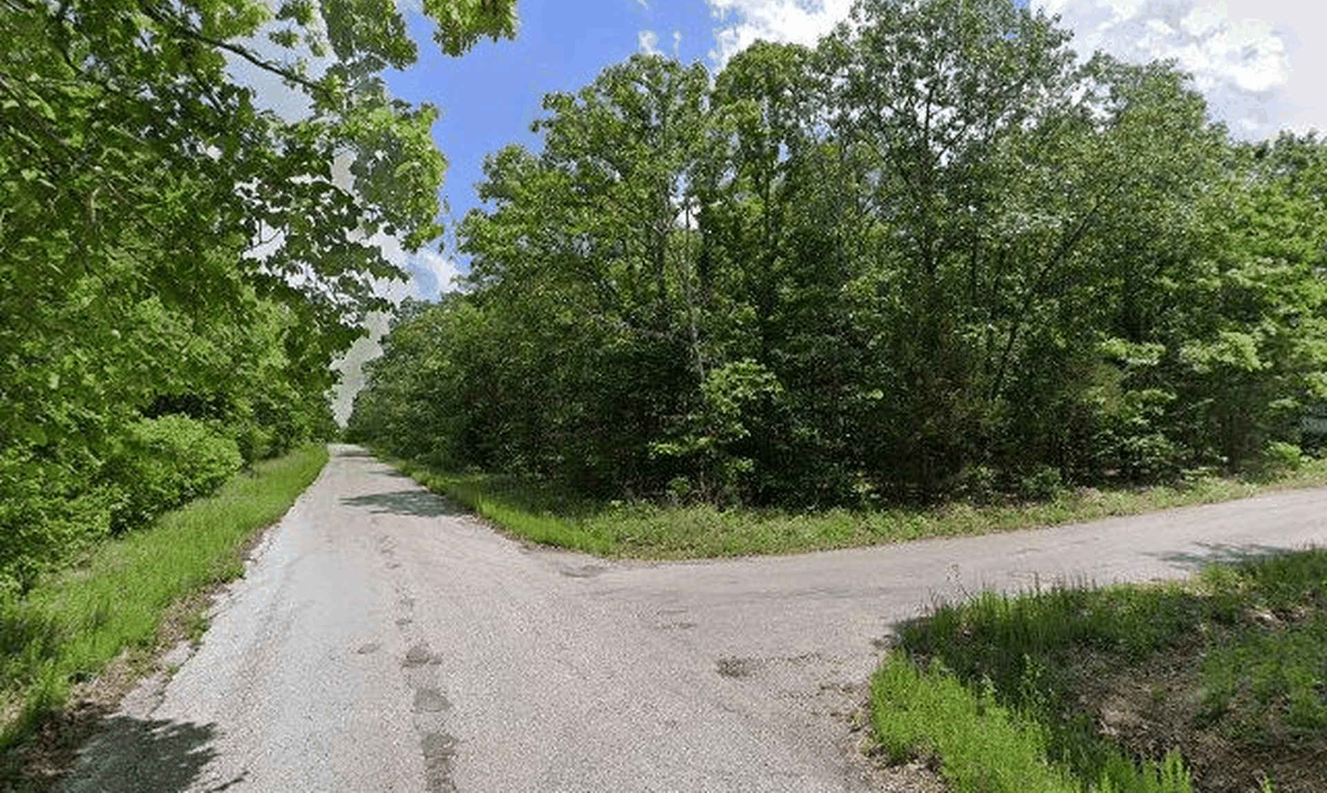 Street-level photo of the paved road through the Spring Addition subdivision where Lot 31 sits
